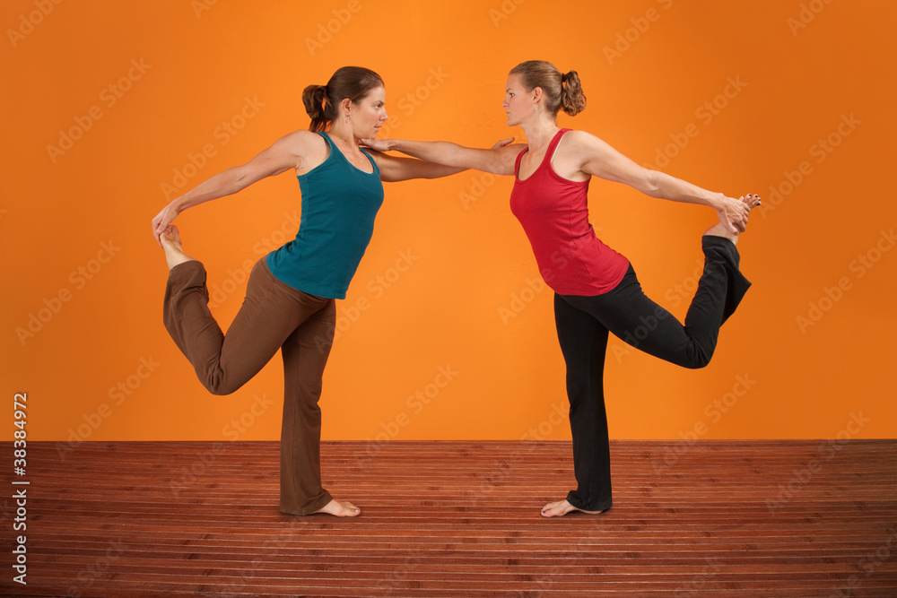 Fototapeta premium Two Women Perform Yoga