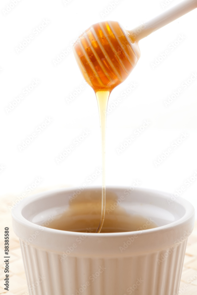 honey running in a bowl honey running in a bowl