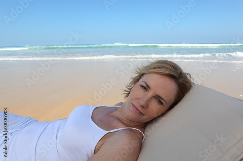 Blond woman relaxing at the beach