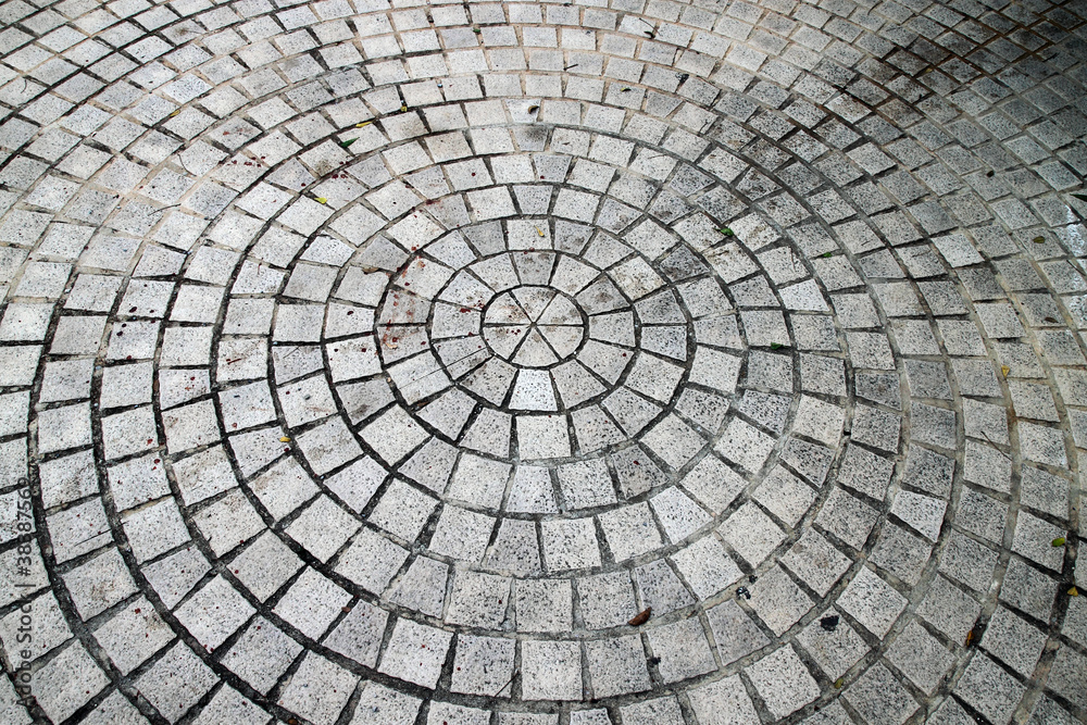 Closeup view on a cobblestone road - circle pattern - background