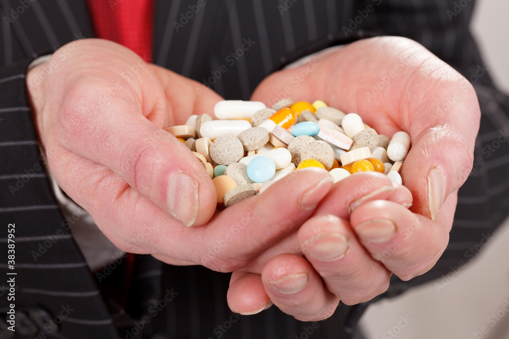 man holding pills man holding pills