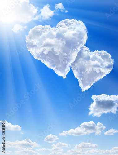 Hearts in clouds against a blue clean sky