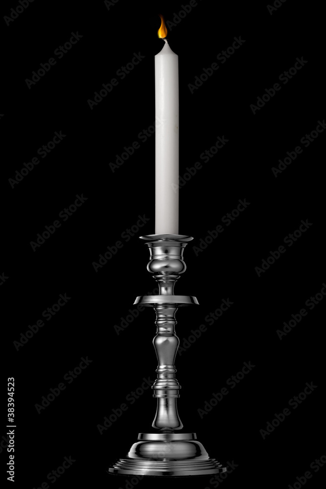 Silver candlestick with candle isolated on black
