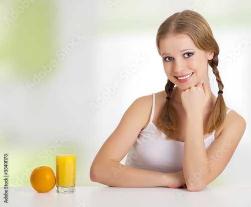 beautiful happy cheerful young woman with orange juice