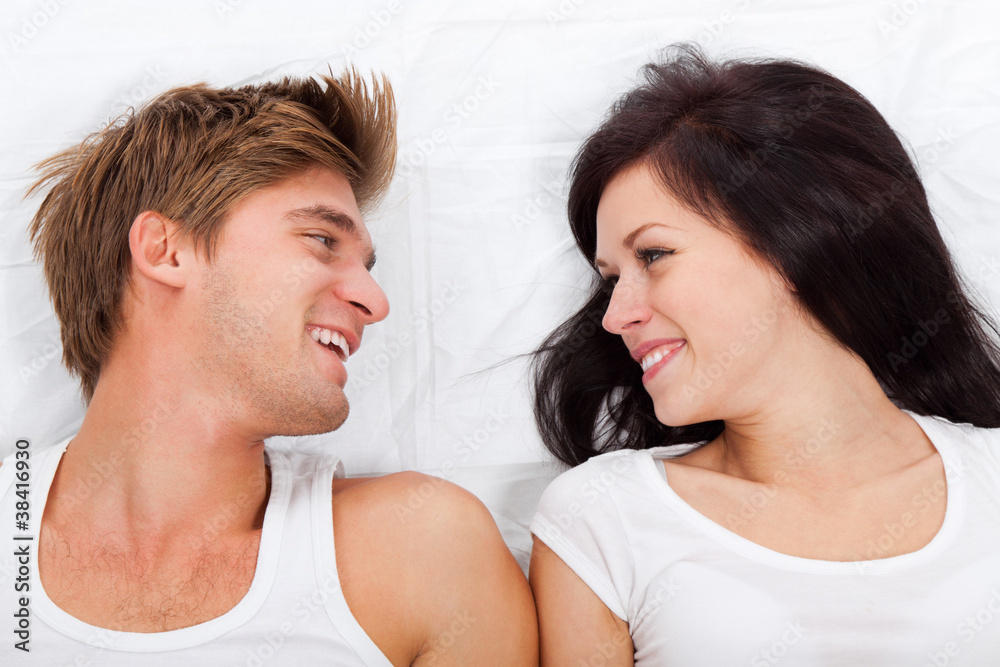 young lovely couple lying in a bed young lovely couple lying in a bed