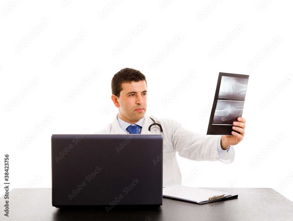 Closeup of doctor at his desk in front of computer analyzing an