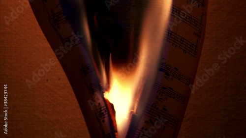 Burning music sheets, dark, closeup,