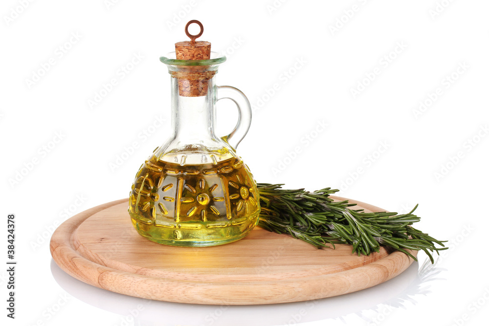 Oil in a bottle and fresh rosemary isolated on white