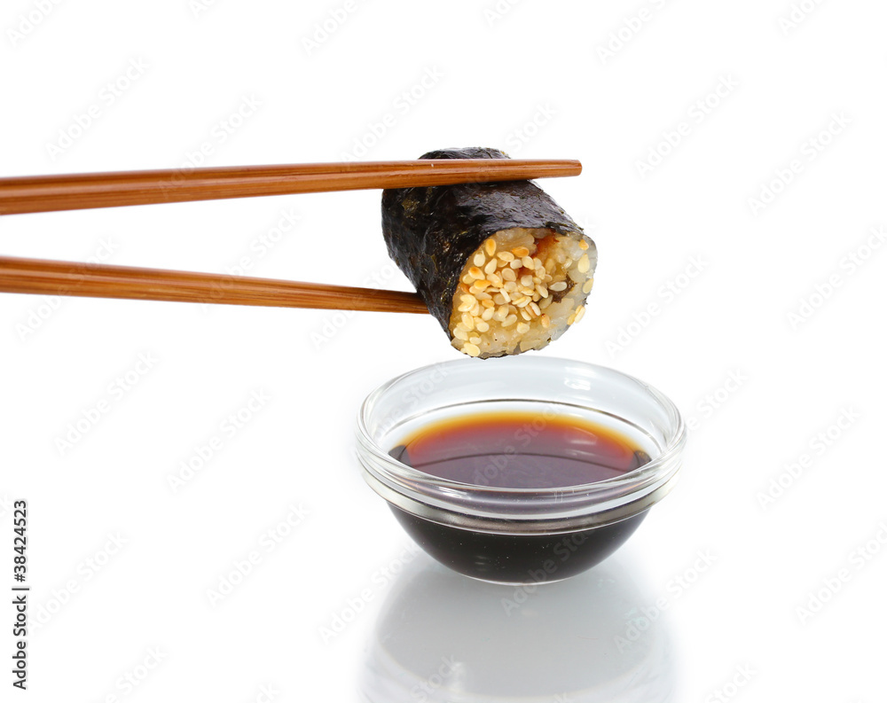 Dipping roll in sauce isolated on white