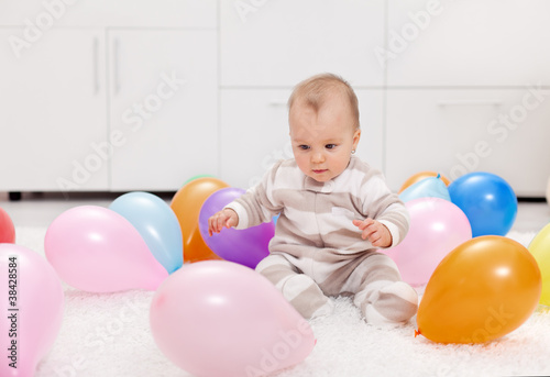 Baby girl with balloons