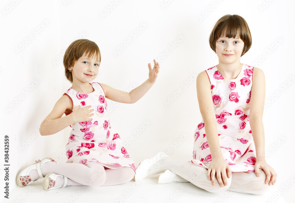 two sisters wearing similar dresses two sisters wearing similar dresses