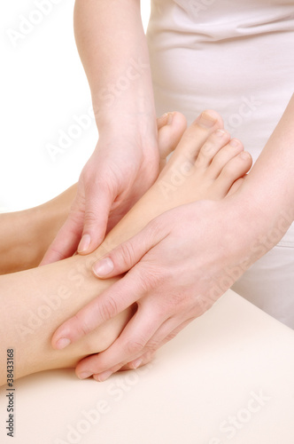 massage the feet of a young woman