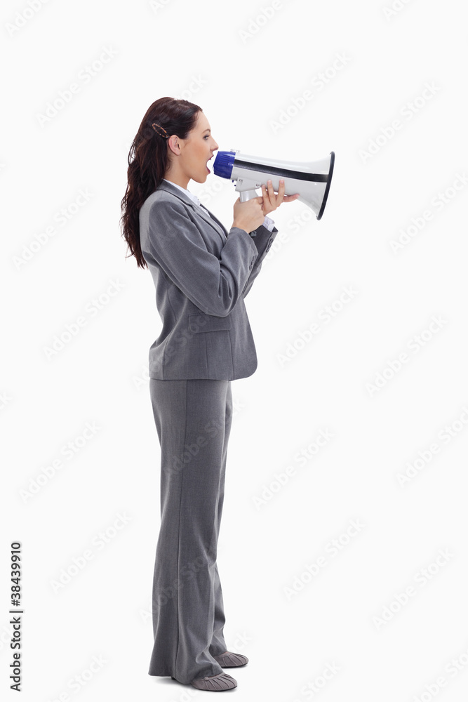 Profile of a businesswoman speaking loudly in a megaphone Profile of a businesswoman speaking loudly in a megaphone