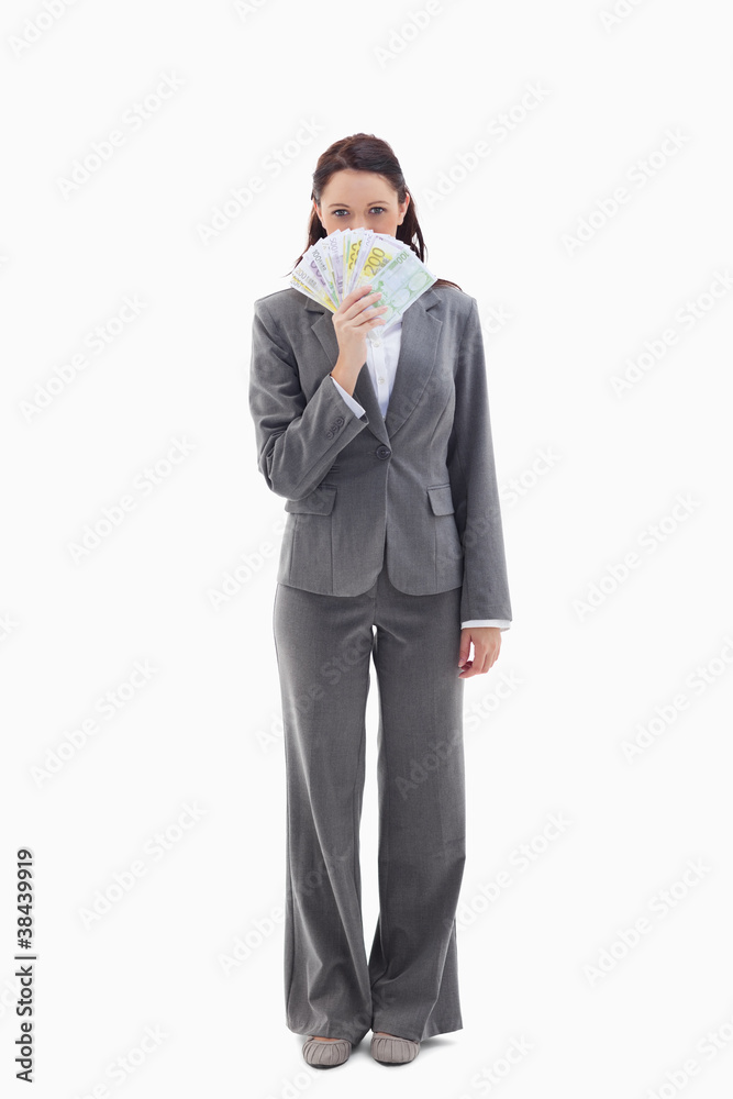 Businesswoman hiding with bank notes in her hand Businesswoman hiding with bank notes in her hand