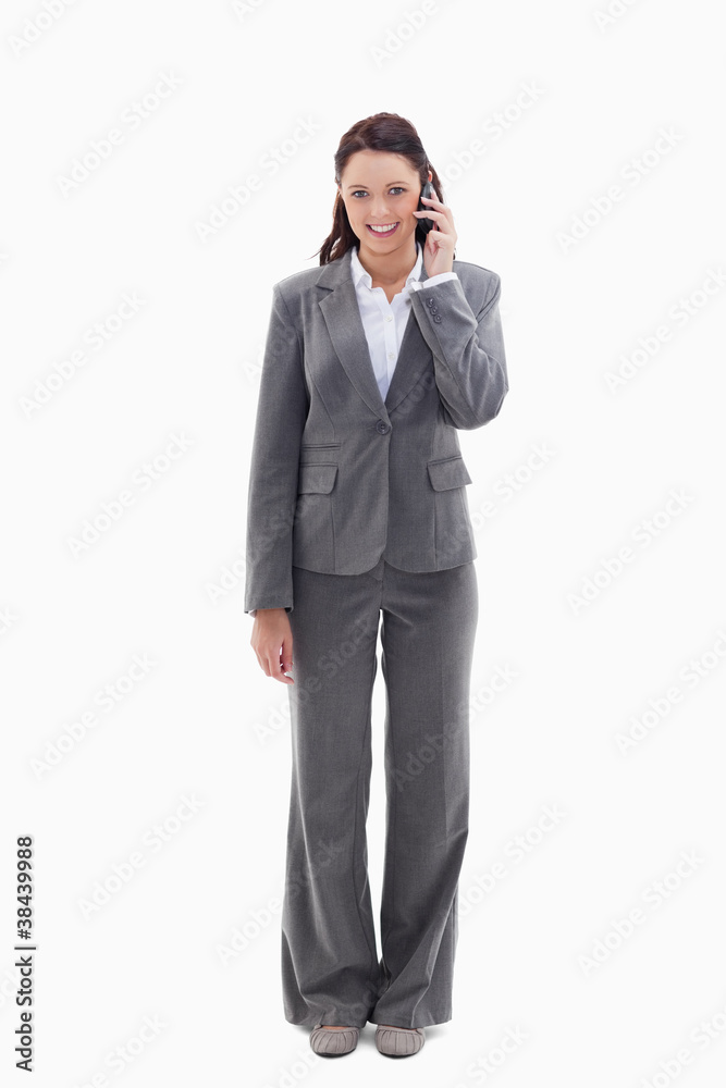 Smiling businesswoman using a phone Smiling businesswoman using a phone