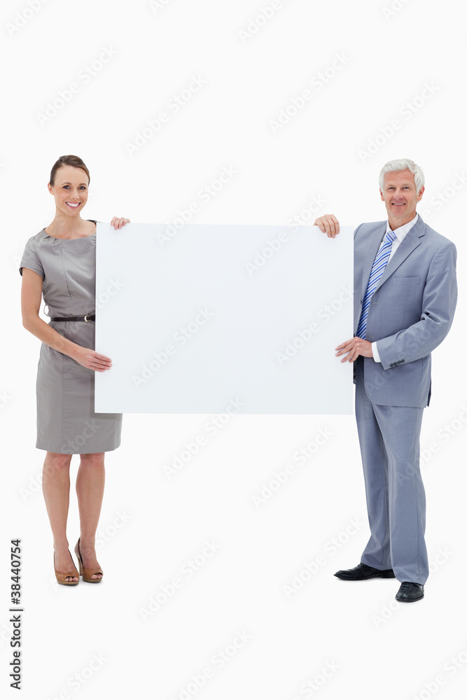 White hair businessman smiling and holding a big white sign with White hair businessman smiling and holding a big white sign with