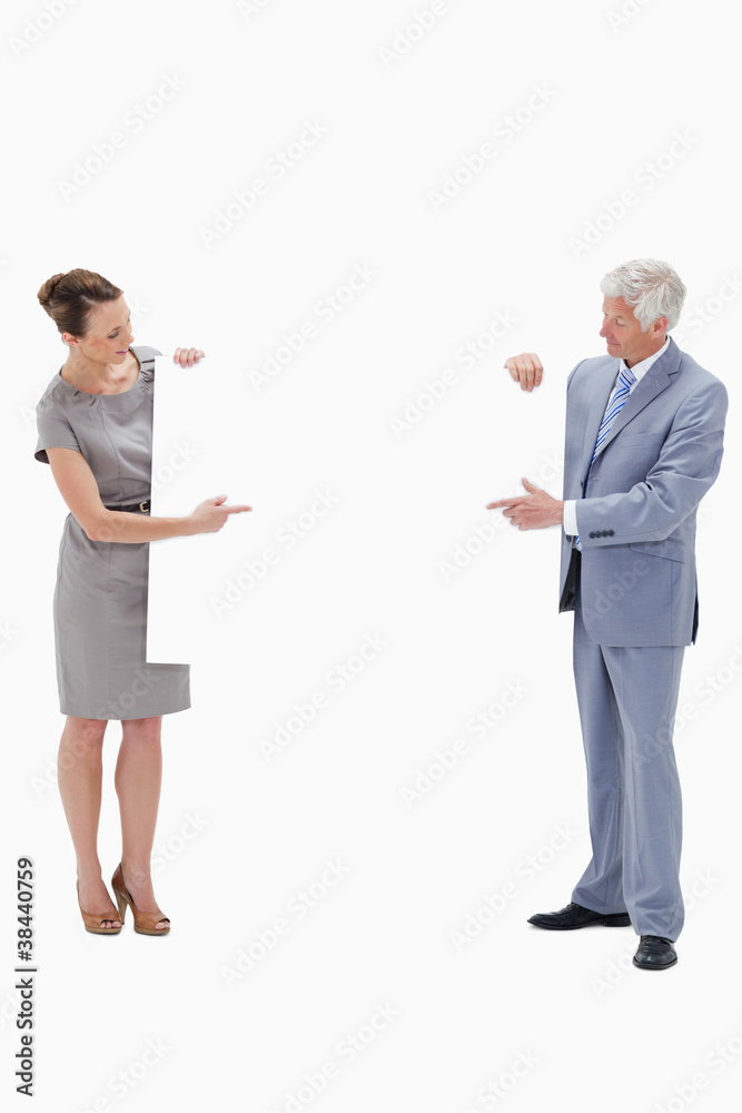 Woman holding and pointing to a big white sign with a white hair Woman holding and pointing to a big white sign with a white hair