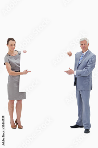 White hair businessman holding and pointing to a big white sign