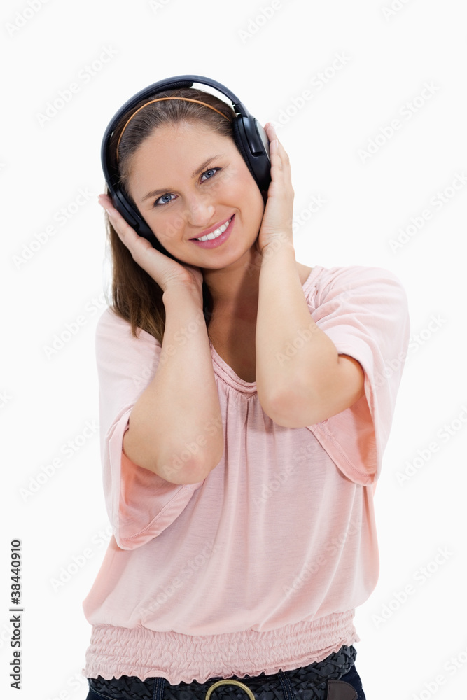 Smiling girl with pink shirt wearing headphones Smiling girl with pink shirt wearing headphones
