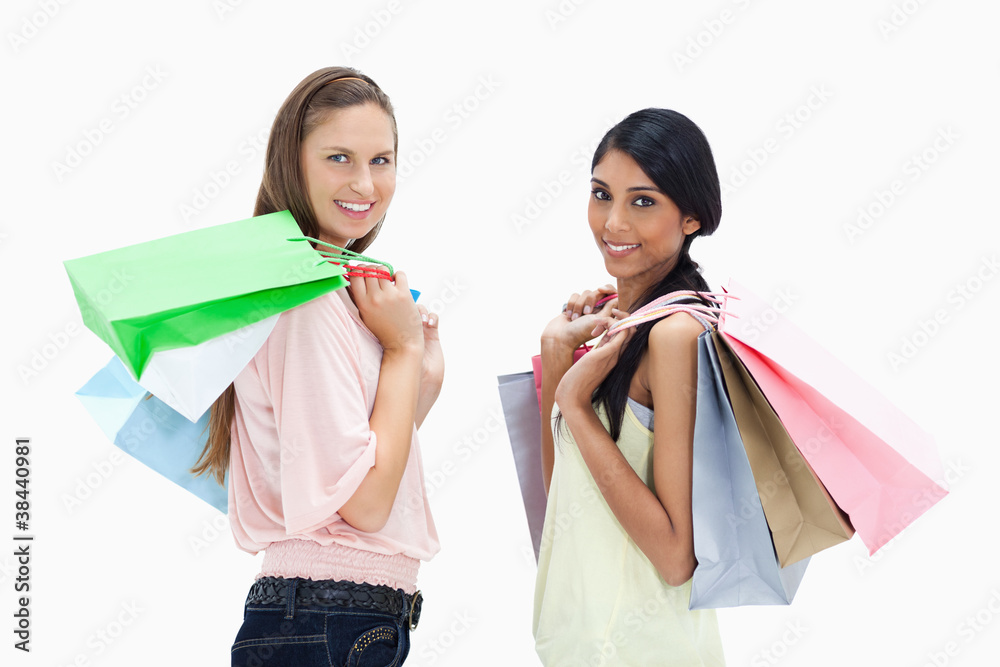 Smiling girls with a lot of shopping bags