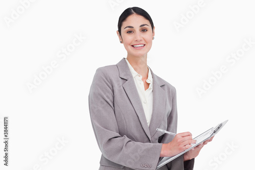 Smiling businesswoman with pen and clipboard