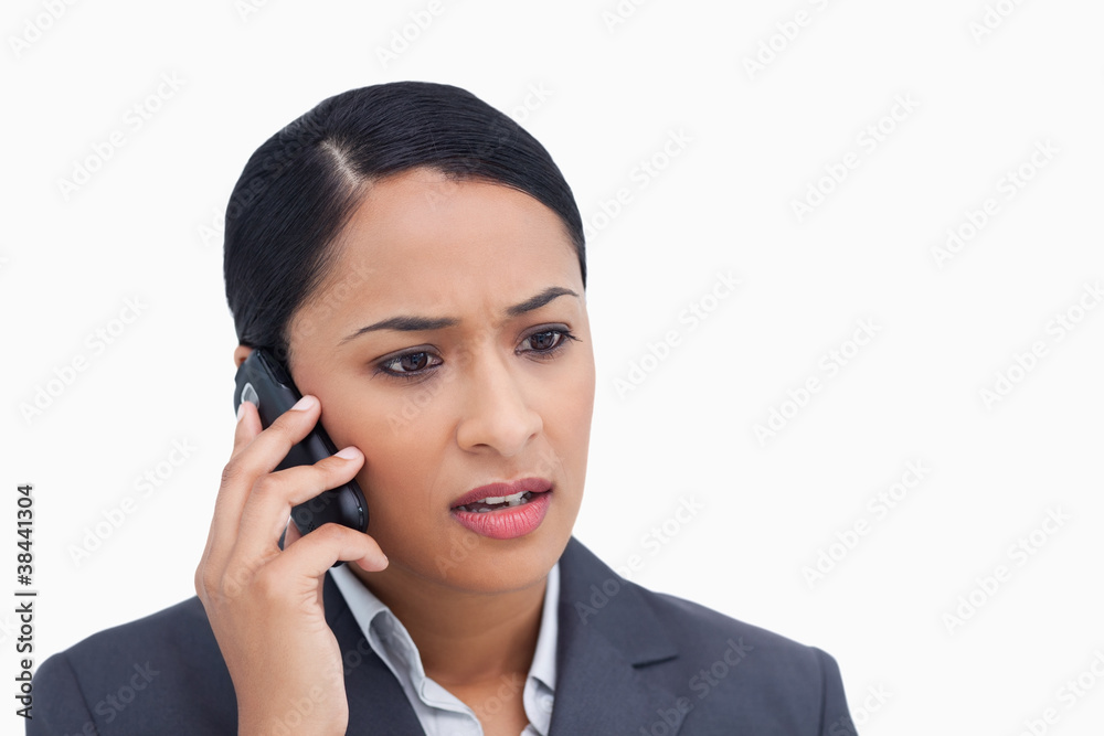 Close up of negative surprised saleswoman on her cellphone Close up of negative surprised saleswoman on her cellphone