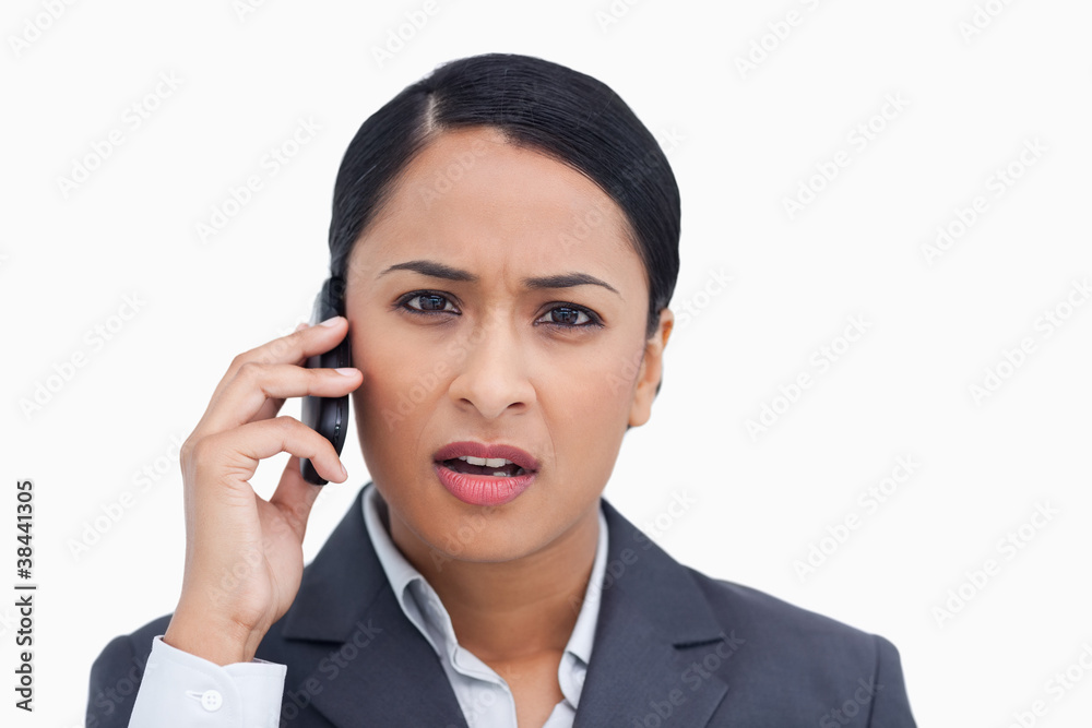 Close up of saleswoman getting bad news from caller Close up of saleswoman getting bad news from caller