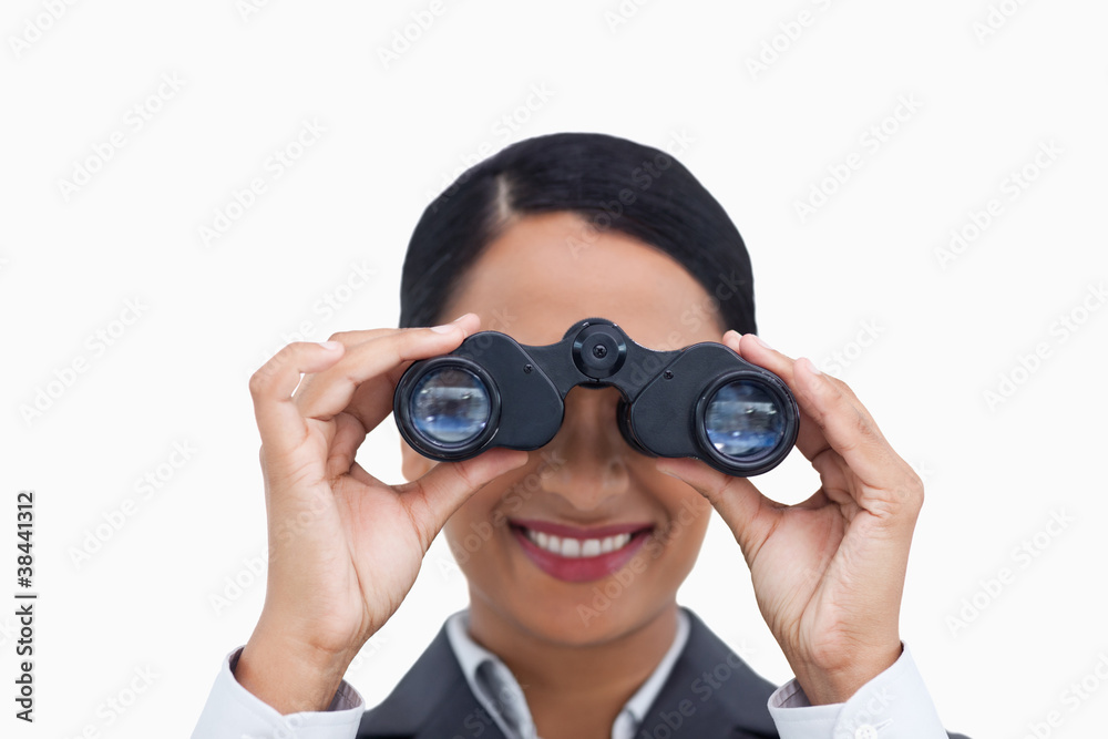 Close up of smiling saleswoman using spy glasses Close up of smiling saleswoman using spy glasses