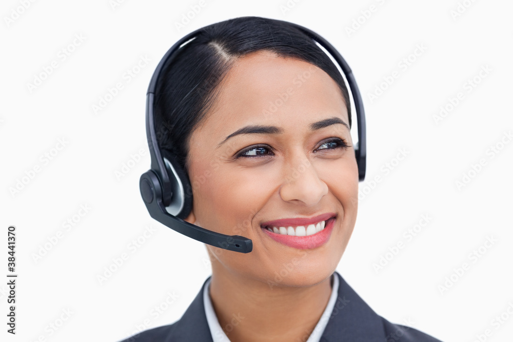 Close up of smiling call center agent looking to the side Close up of smiling call center agent looking to the side