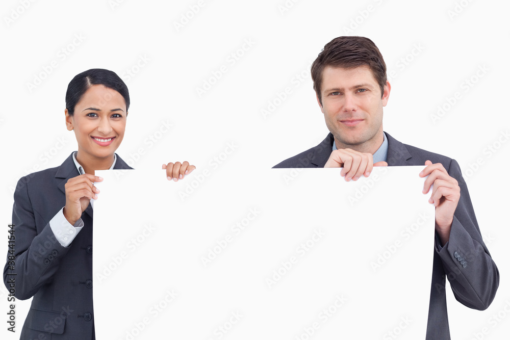 Close up of salesteam holding blank sign Close up of salesteam holding blank sign
