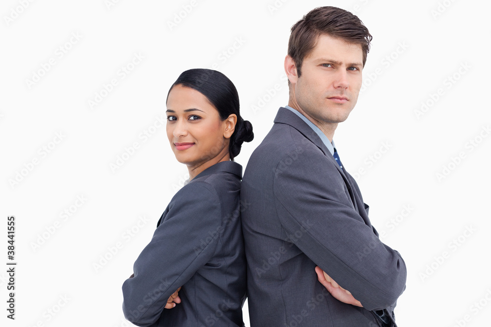 Close up of serious salesteam standing back to back Close up of serious salesteam standing back to back