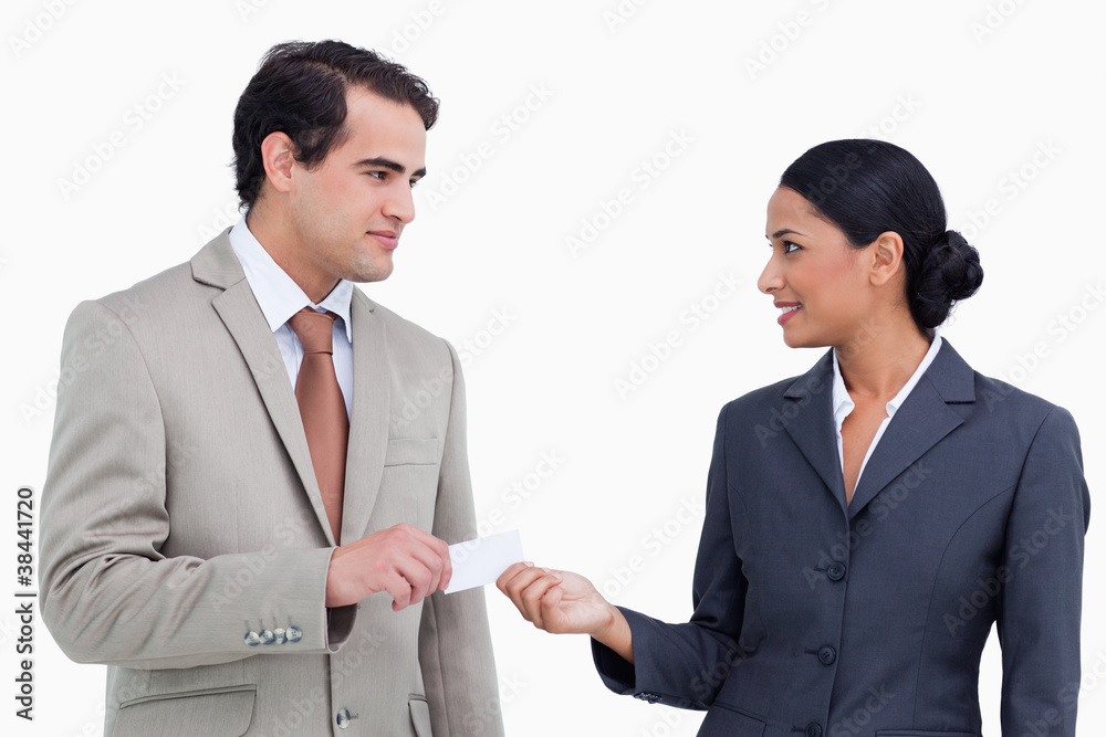 Saleswoman handing business card over to costumer Saleswoman handing business card over to costumer