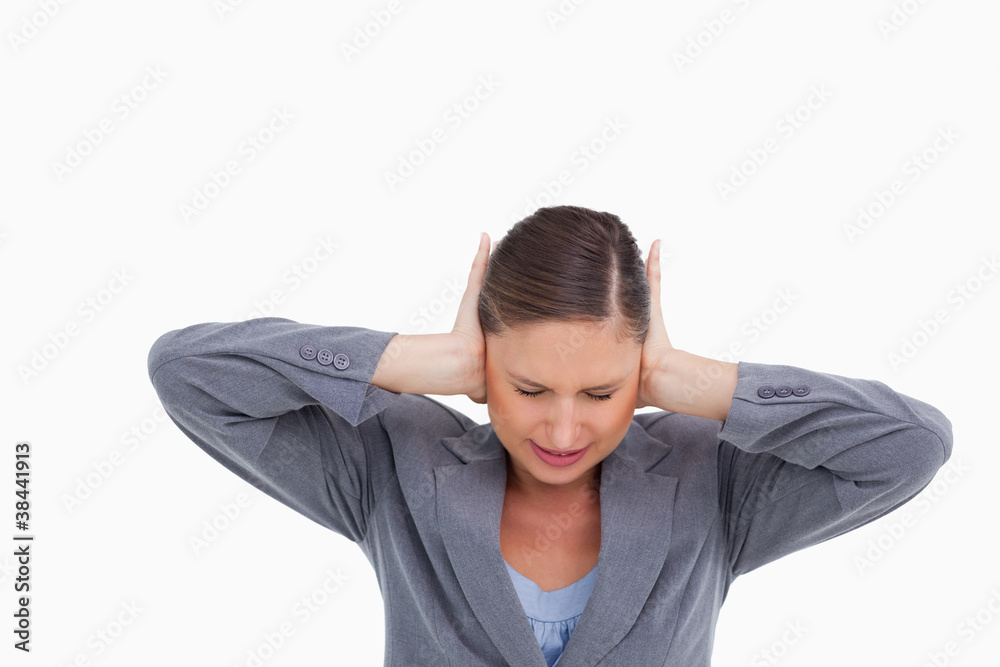 Close up of irritated tradeswoman covering her ears Close up of irritated tradeswoman covering her ears