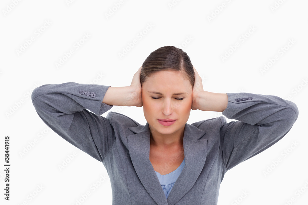 Close up of annoyed tradeswoman covering her ears Close up of annoyed tradeswoman covering her ears