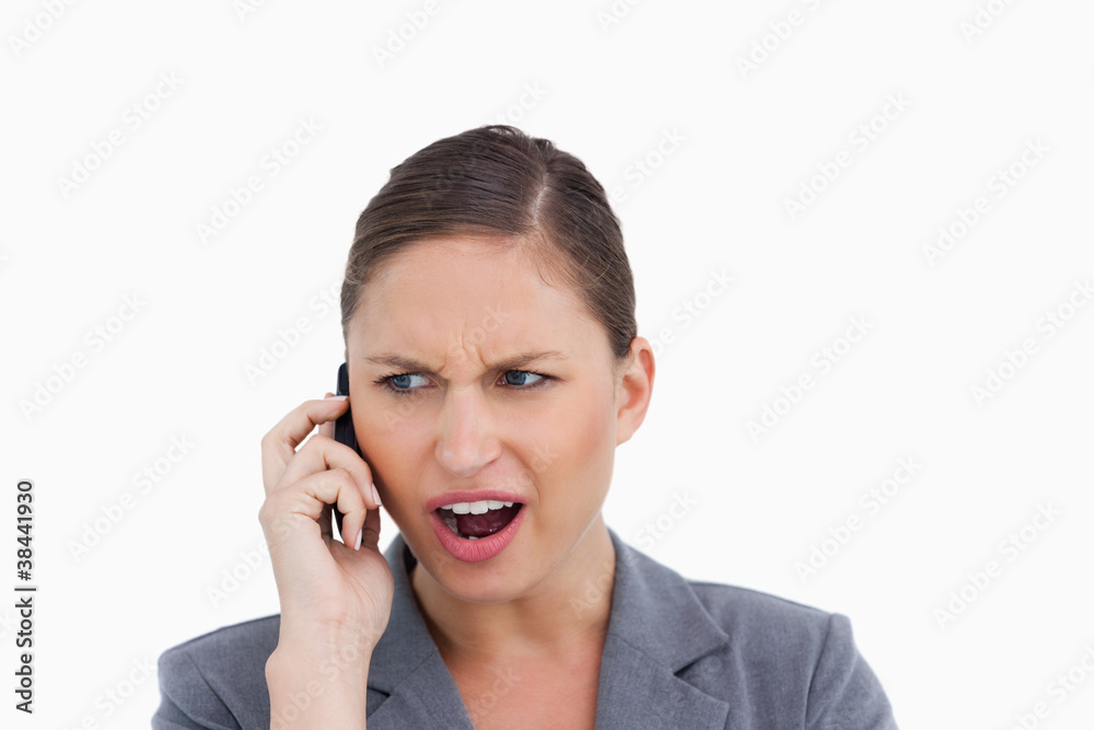 Close up of angry tradeswoman yelling at caller Close up of angry tradeswoman yelling at caller
