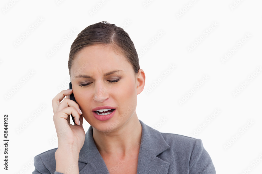 Close up of angry tradeswoman shouting at caller Close up of angry tradeswoman shouting at caller
