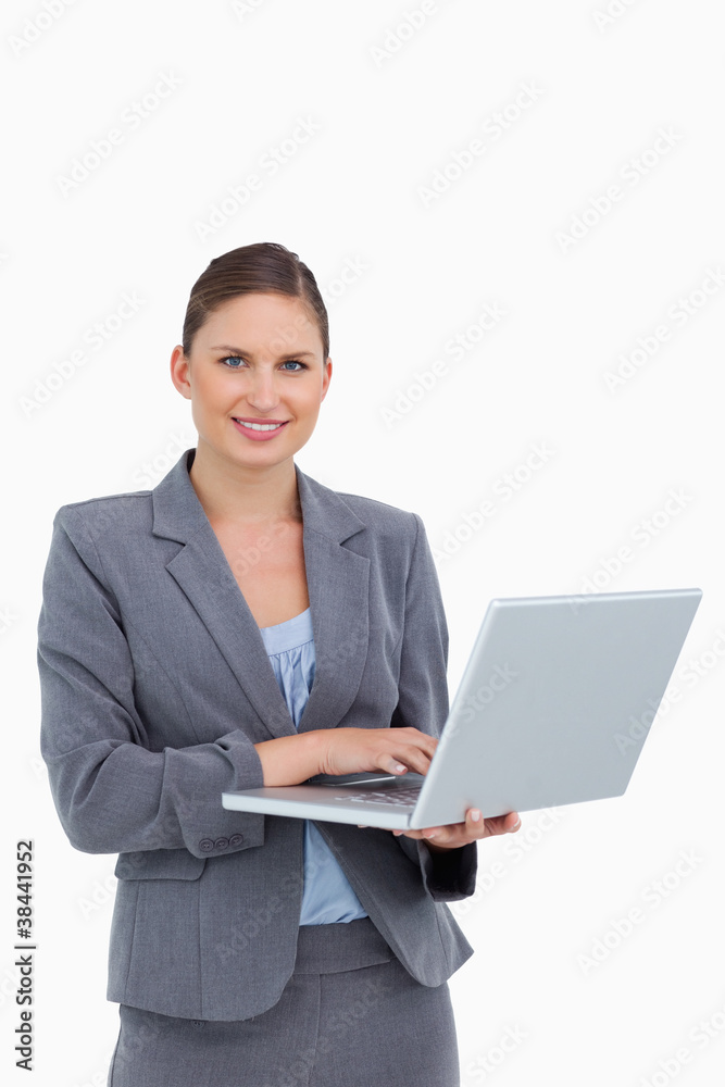 Smiling tradeswoman with her laptop Smiling tradeswoman with her laptop