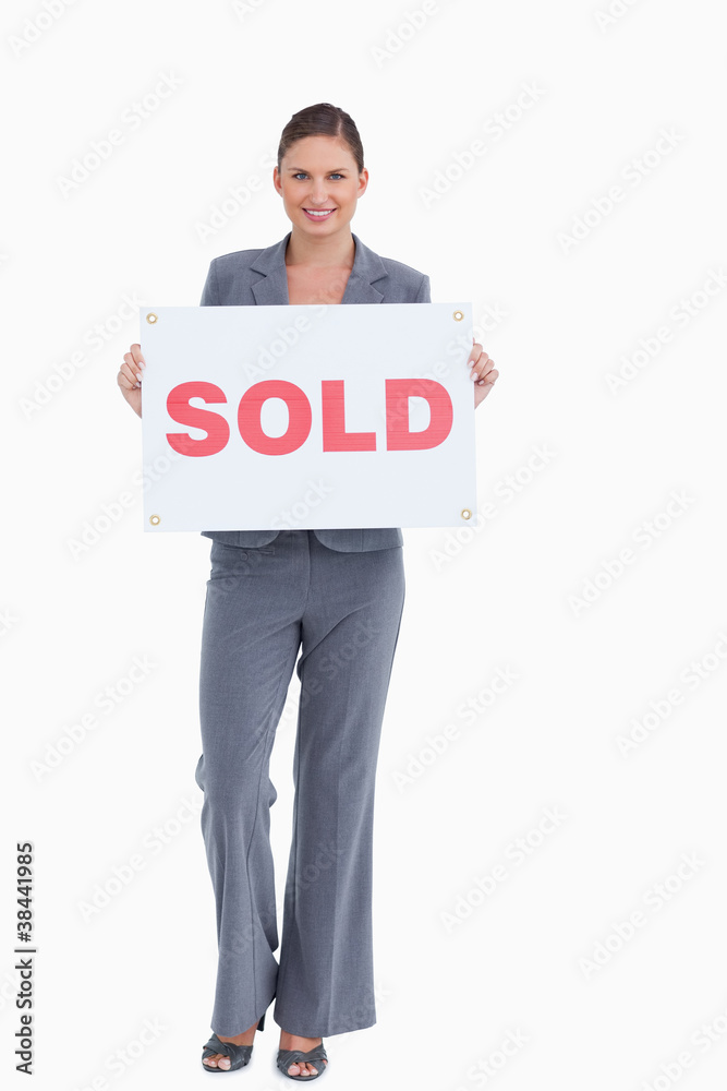 Happy real estate agent holding sold sign Happy real estate agent holding sold sign