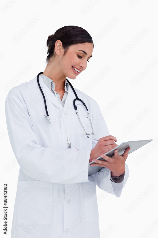 Side view of female doctor taking notes Side view of female doctor taking notes