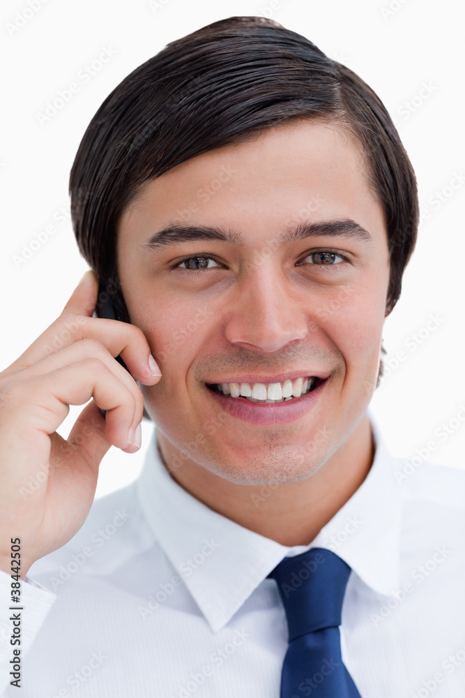 Close up of smiling tradesman on his mobile phone Close up of smiling tradesman on his mobile phone