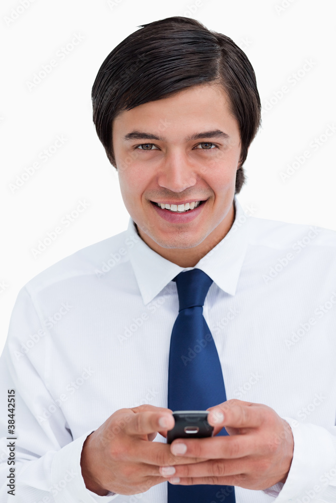 Close up of smiling tradesman holding his cellphone Close up of smiling tradesman holding his cellphone