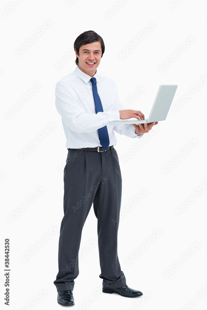 Side view of smiling tradesman with his laptop Side view of smiling tradesman with his laptop