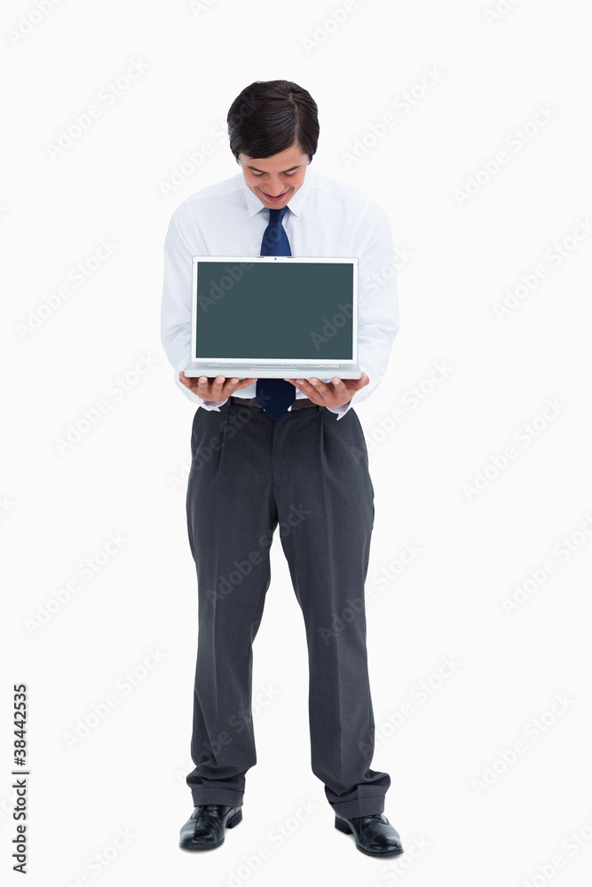 Tradesman looking at laptop screen he is presenting Tradesman looking at laptop screen he is presenting