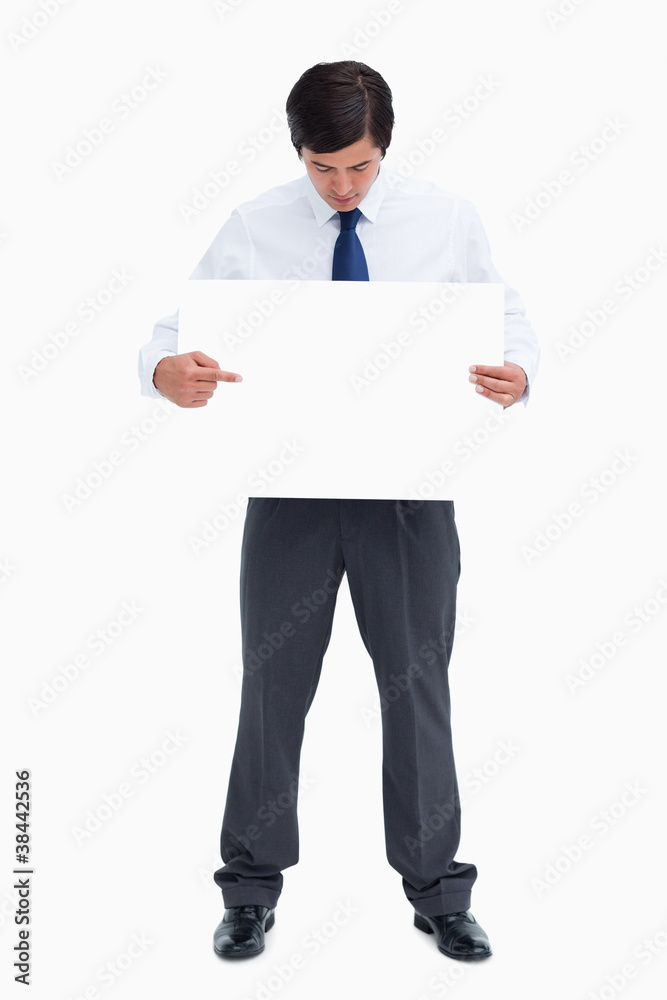 Tradesman pointing at blank sign in his hand Tradesman pointing at blank sign in his hand