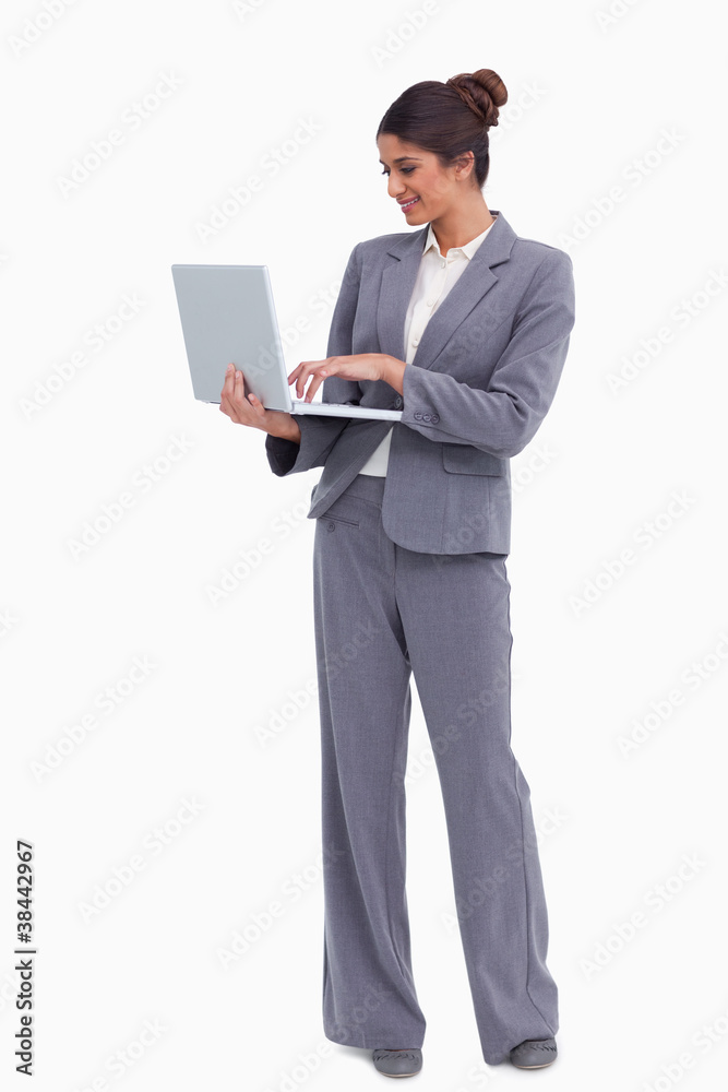 Smiling female entrepreneur working on her laptop Smiling female entrepreneur working on her laptop