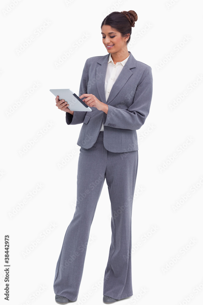 Smiling female entrepreneur working on her tablet computer Smiling female entrepreneur working on her tablet computer
