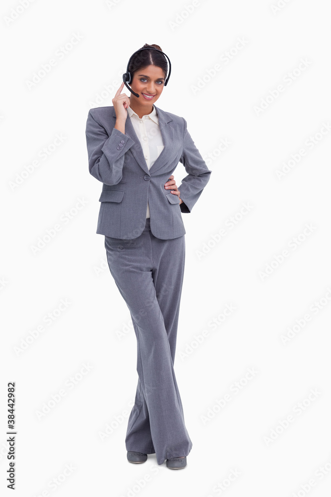 Smiling female call center agent with her legs crossed Smiling female call center agent with her legs crossed