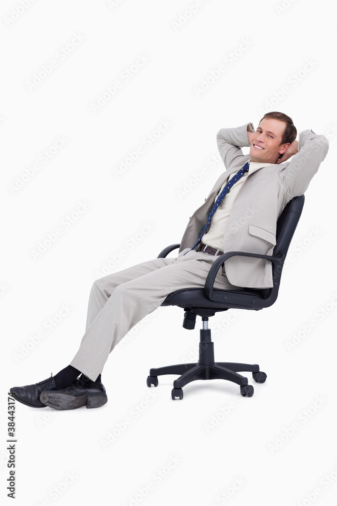 Side view of smiling businessman leaning back in his chair Side view of smiling businessman leaning back in his chair