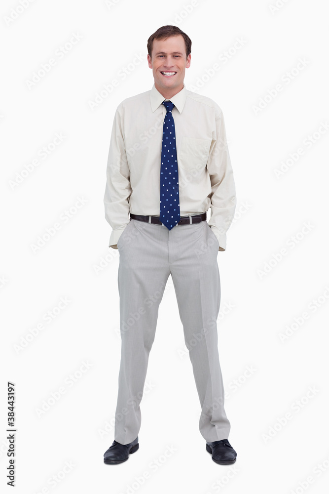 Smiling young businessman with his hands in his pockets Smiling young businessman with his hands in his pockets