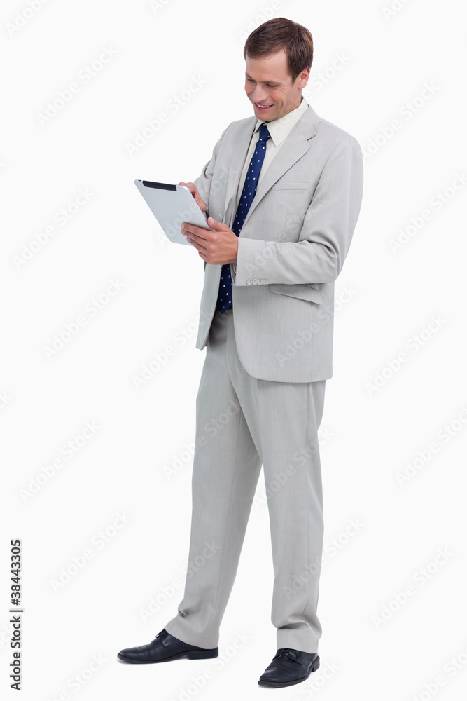 Smiling businessman using tablet computer